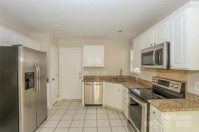a kitchen with a stove a sink and a refrigerator