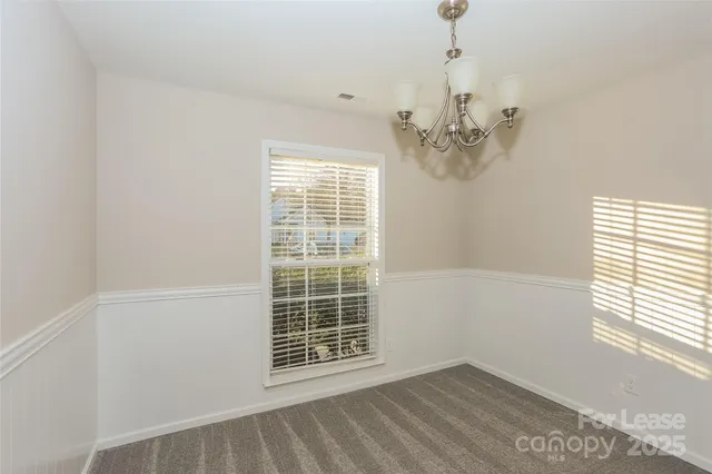 an empty room with windows and entrance