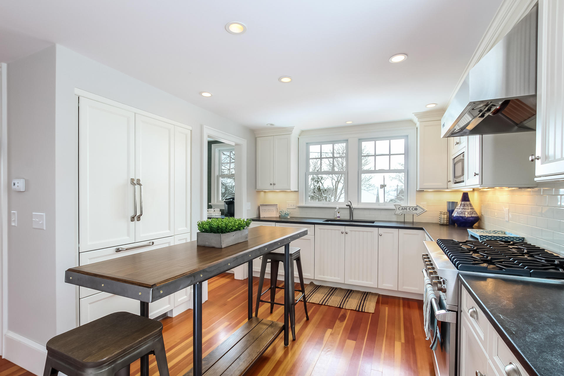 38 Mill Pond Road Chatham, MA 02633 - Photo 7 of 30 a kitchen with granite countertop a stove a sink and a refrigerator