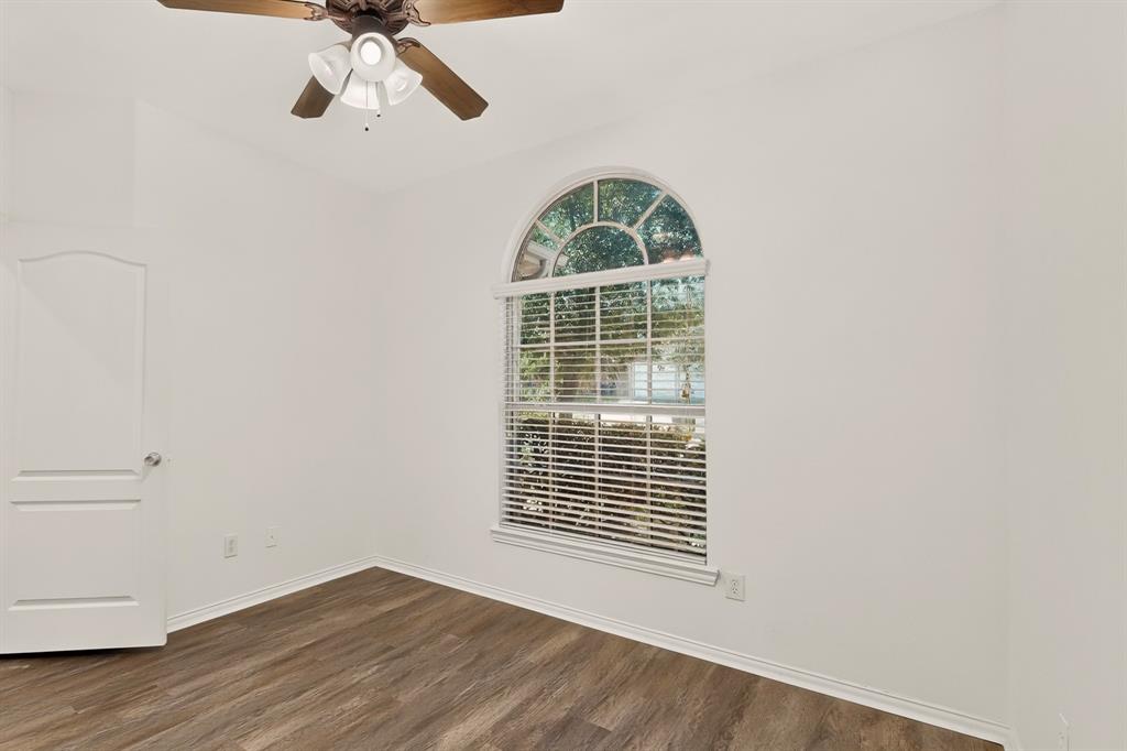 14908 Riverside Drive Little Elm, TX 75068 - Photo 32 of 40 Arched window with blinds, wood-finish flooring, ceiling fan, and white interior paint