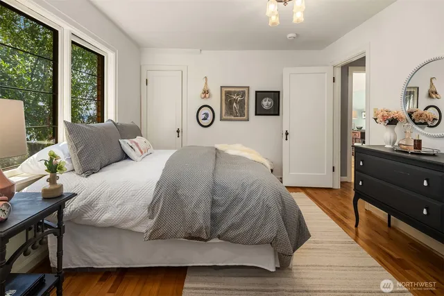 a bed sitting in a bedroom next to a window