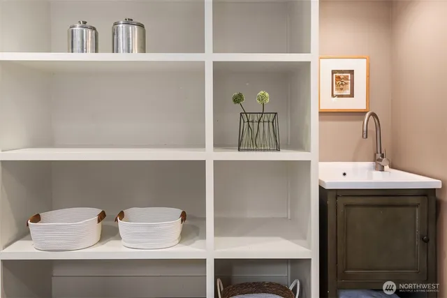 a view of a bedroom with wooden floor and windows
