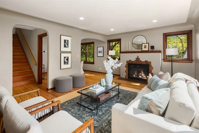 a living room with furniture a window and a fireplace