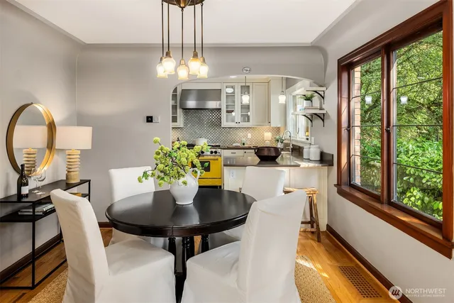 a view of a dining room with furniture a chandelier and wooden floor