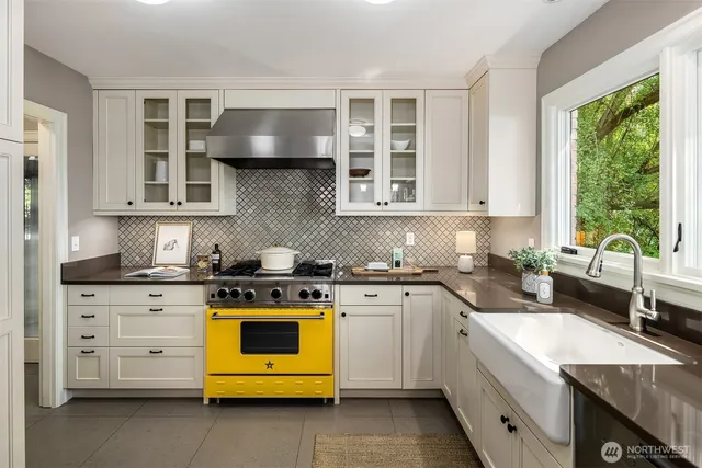 a kitchen with stainless steel appliances granite countertop a stove and a sink