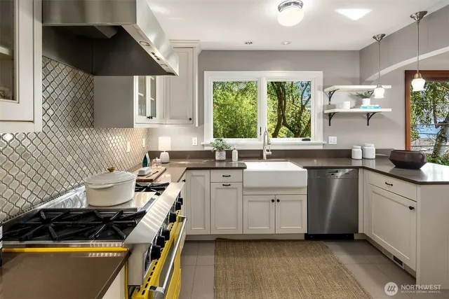 a kitchen with a sink stove and cabinets