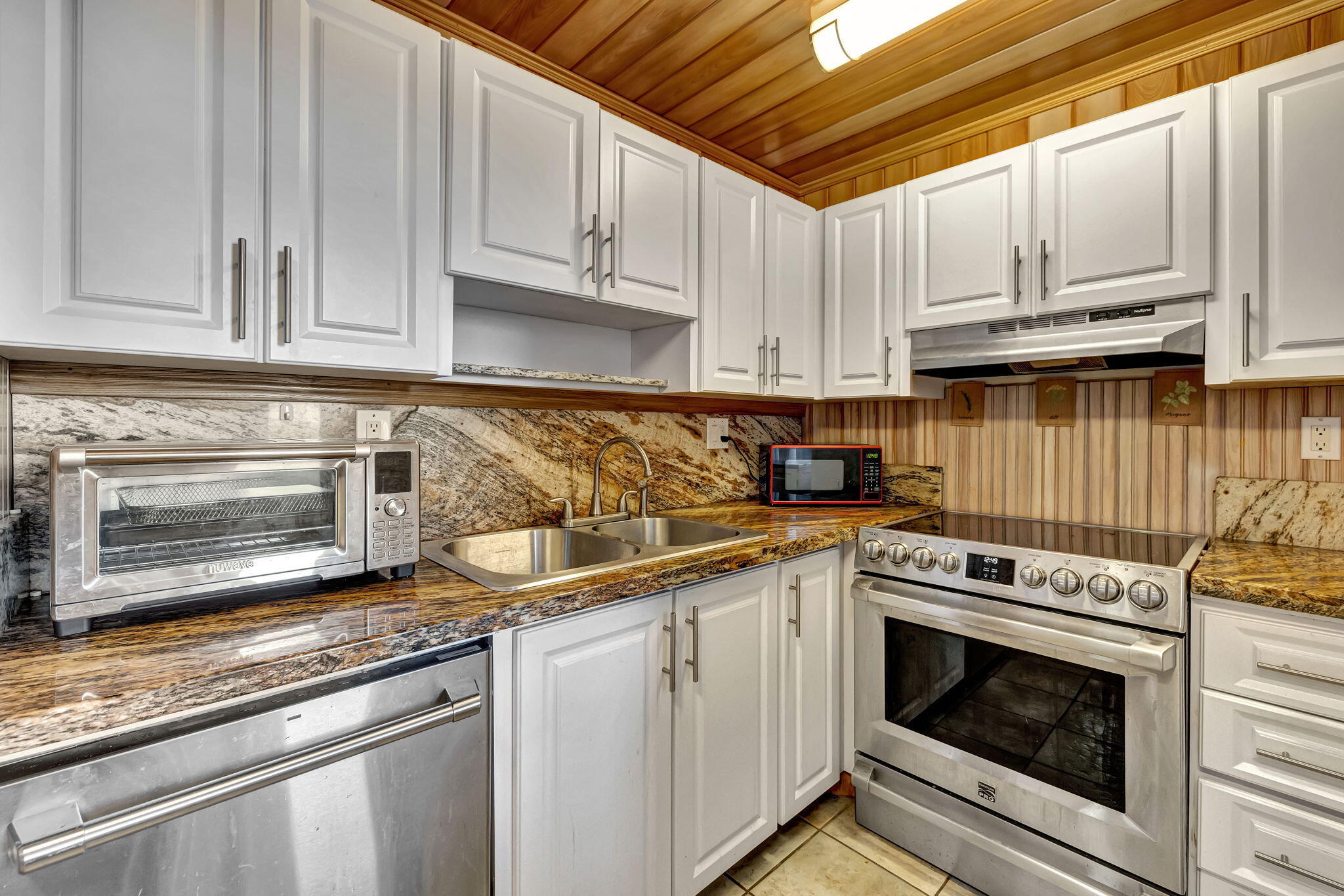 3910 Inverrary Boulevard, Unit 601B Lauderhill, FL 33319 - Photo 15 of 56 a kitchen with granite countertop white cabinets and appliances