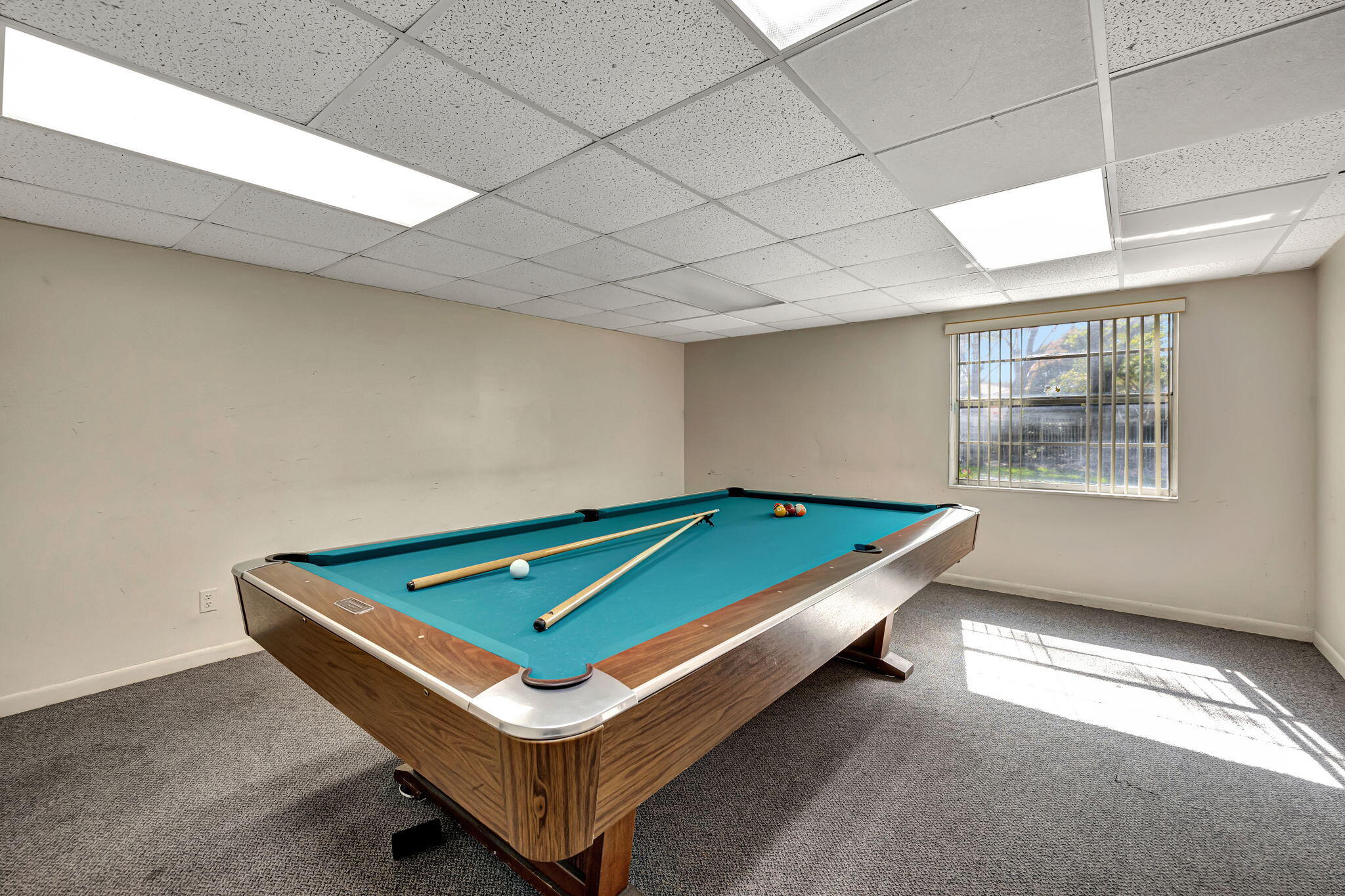 3910 Inverrary Boulevard, Unit 601B Lauderhill, FL 33319 - Photo 46 of 56 a room with pool table and windows