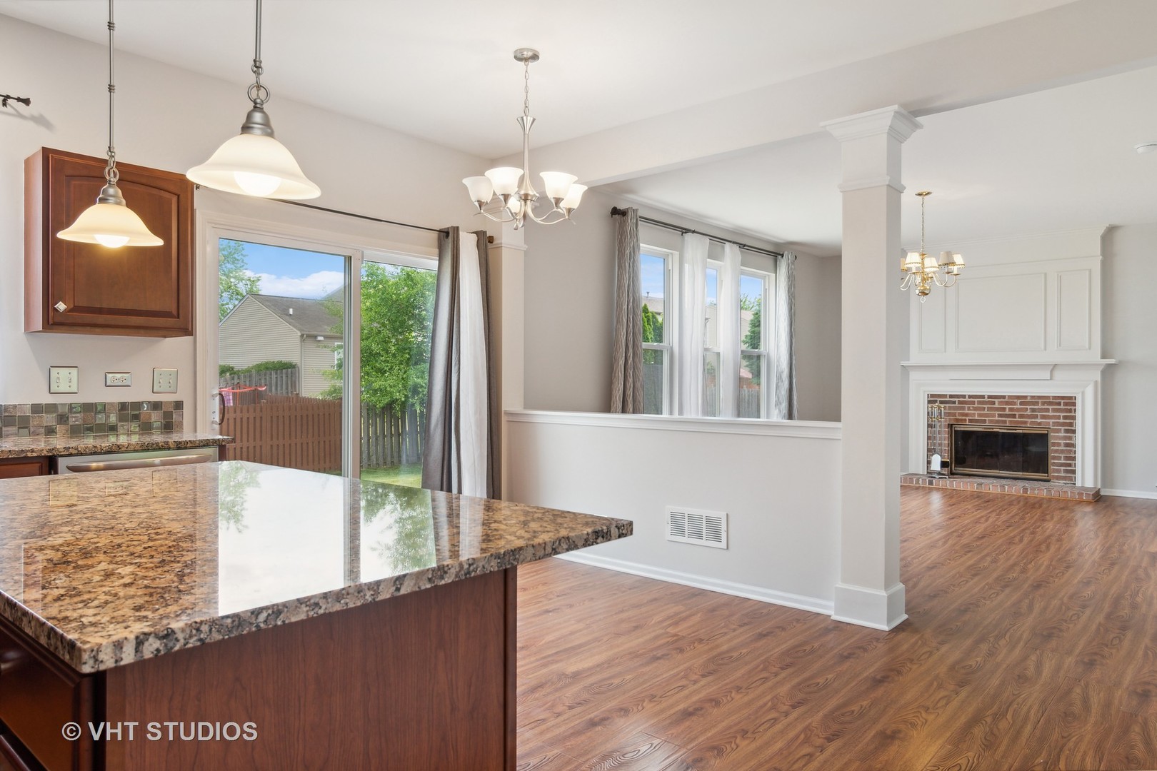 11751 Glenn Circle Plainfield, IL 60585 - Photo 6 of 19 a view of a living room a chandelier and fireplace