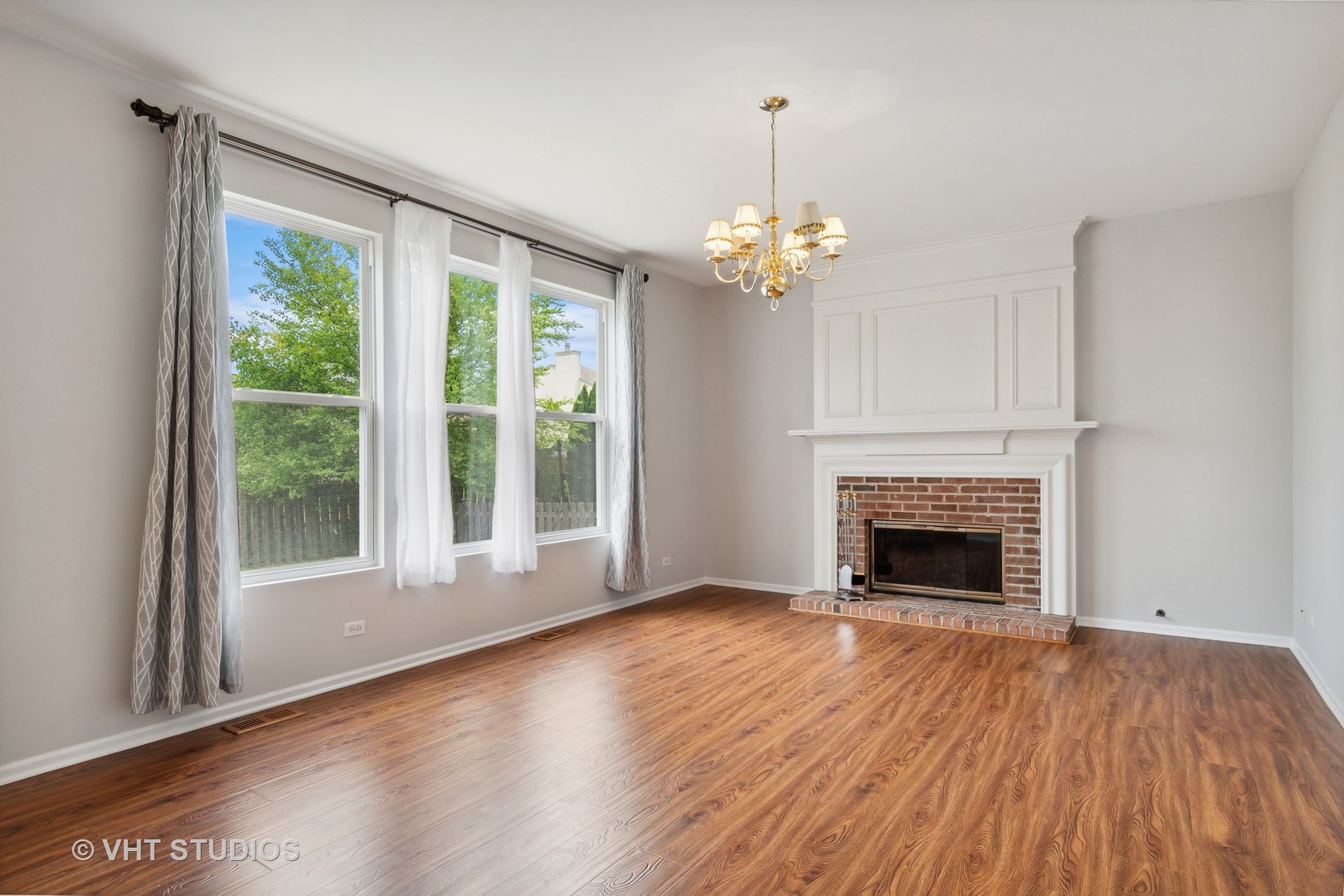 11751 Glenn Circle Plainfield, IL 60585 - Photo 9 of 19 a view of empty room with wooden floor fireplace and a window