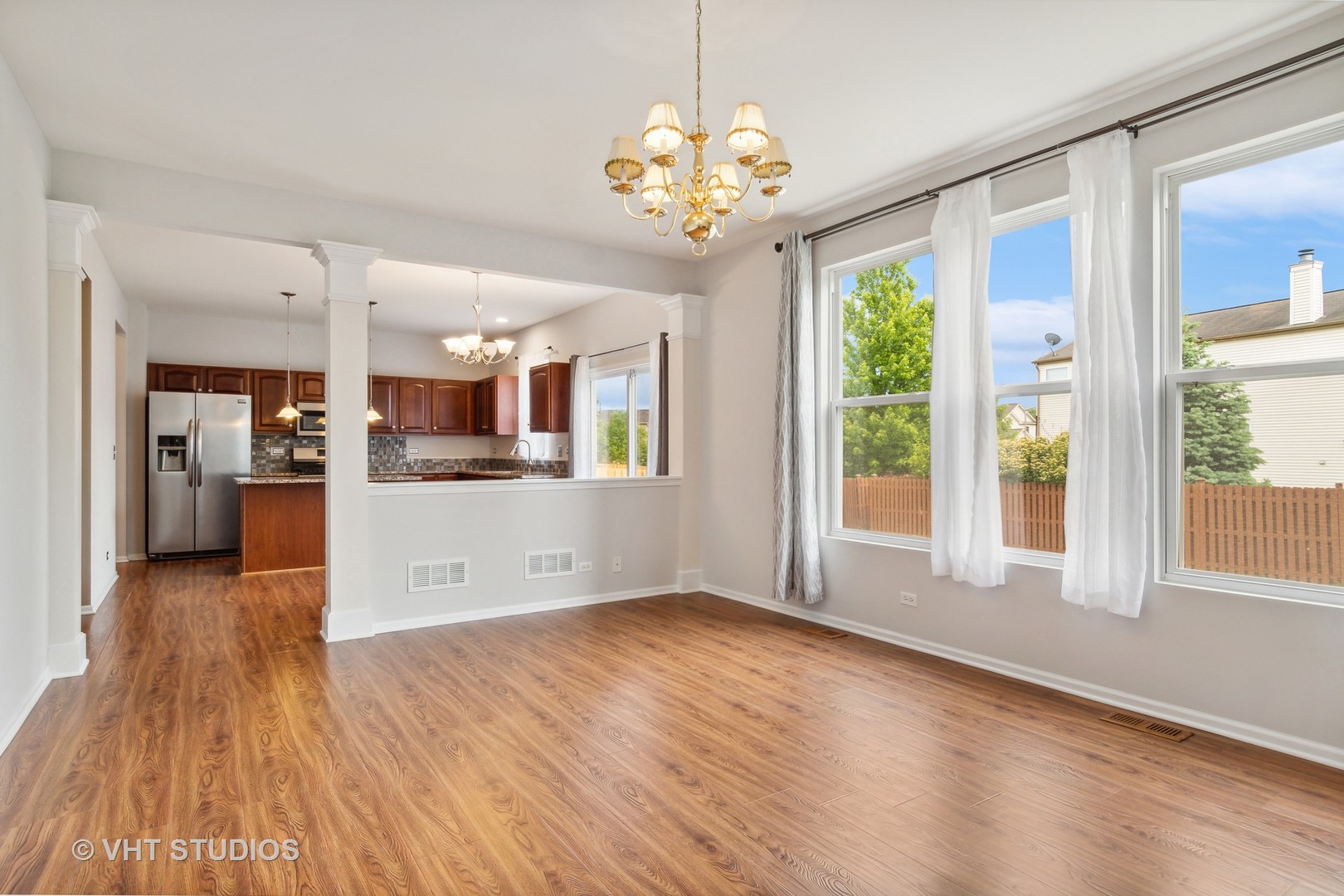 11751 Glenn Circle Plainfield, IL 60585 - Photo 10 of 19 a view of a kitchen with furniture wooden floor and a large window