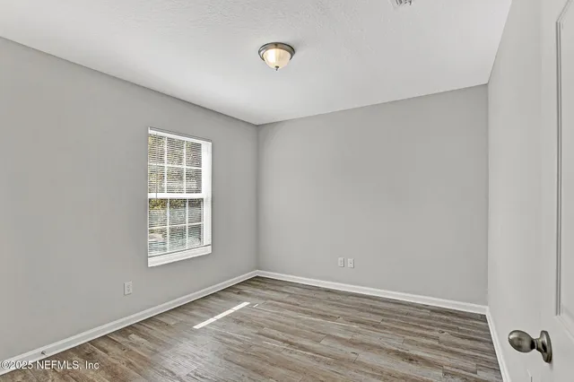 a bedroom with a bed and flat screen tv