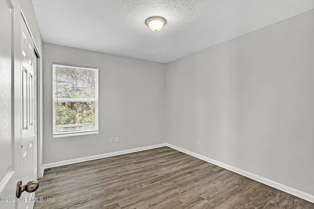 a bedroom with a bed and a potted plant