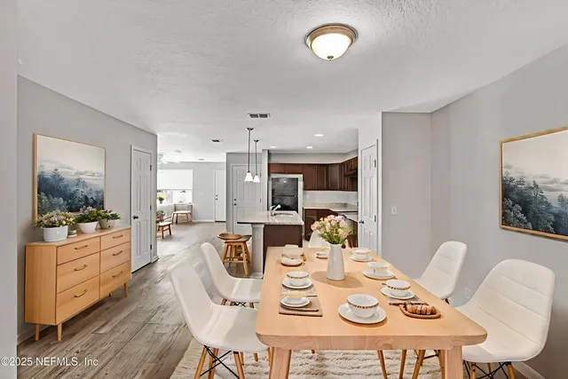 a large kitchen with stainless steel appliances a large counter top a sink a stove and a refrigerator