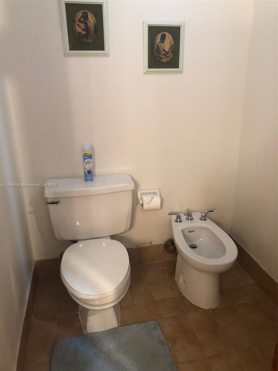 1350 Southwest 122nd Avenue, Unit 423 Miami, FL 33184 - Photo 7 of 8 a white toilet sitting next to a white walls