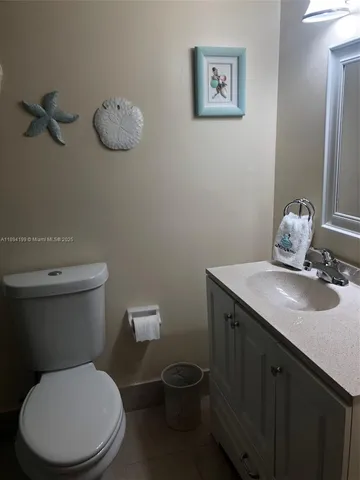 a white toilet sitting next to a bathroom sink