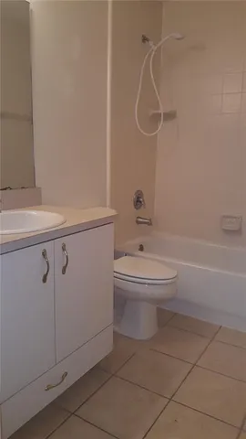 a bathroom with a toilet sink and shower