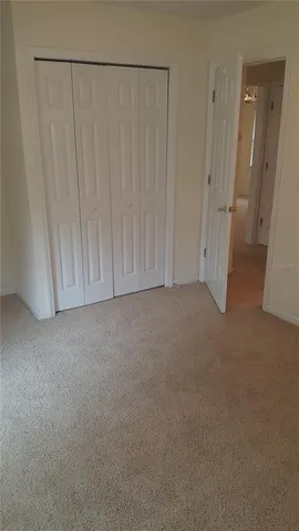 a view of a closet area with hardwood floor