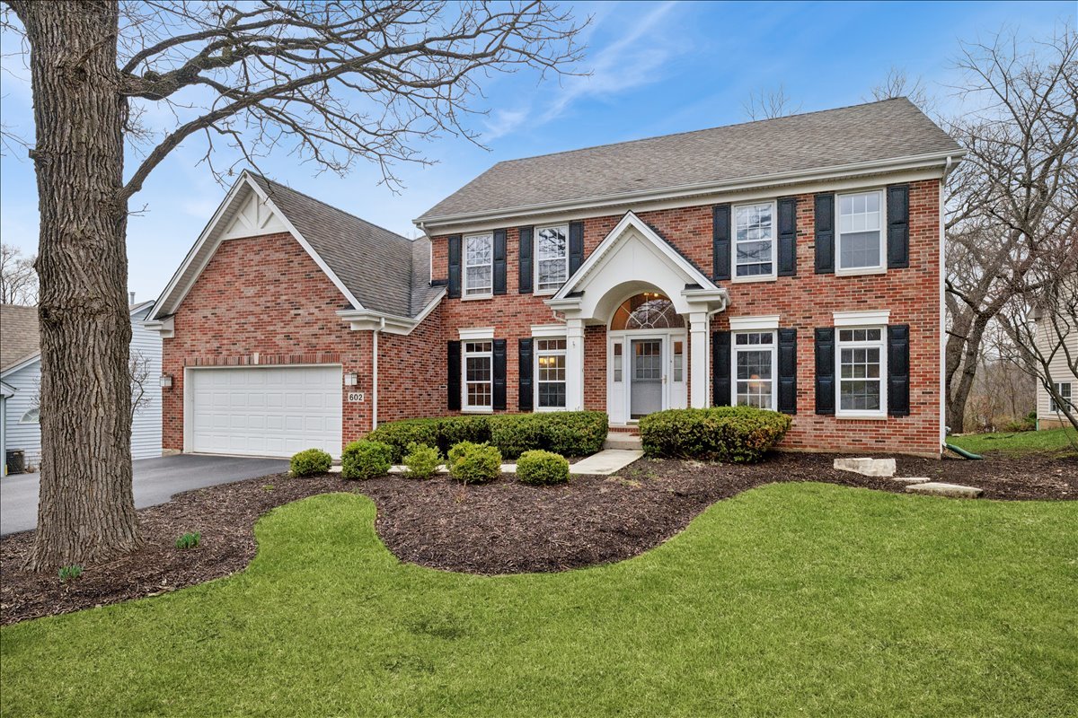 602 Birch Lane Fox River Grove, IL 60021 - Photo 1 of 37 a front view of a house with a garden and plants