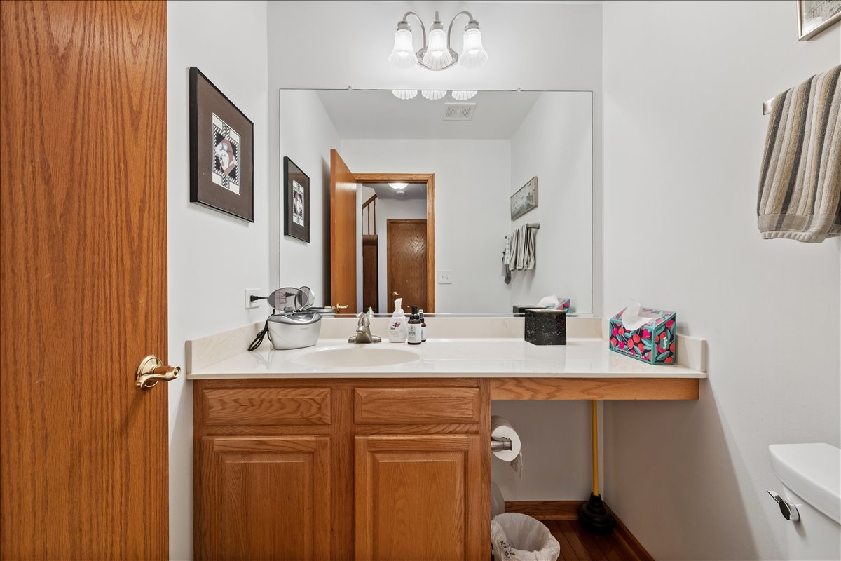 602 Birch Lane Fox River Grove, IL 60021 - Photo 25 of 37 a bathroom with a sink a toilet and a mirror