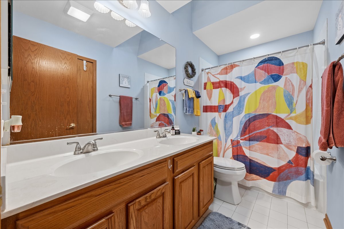 602 Birch Lane Fox River Grove, IL 60021 - Photo 26 of 37 a bathroom with a sink a toilet and shower curtain
