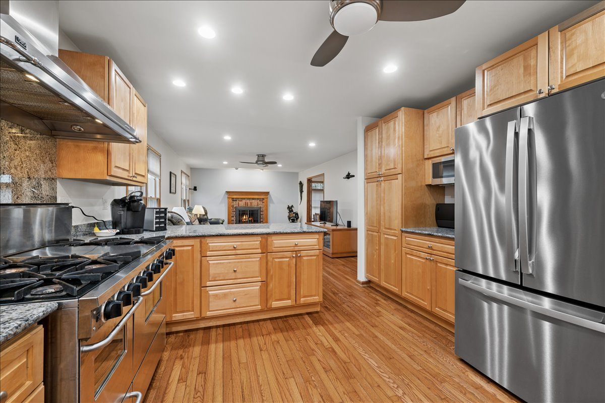 602 Birch Lane Fox River Grove, IL 60021 - Photo 4 of 37 a kitchen with stainless steel appliances granite countertop a refrigerator a stove and a wooden floors