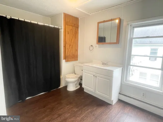 a spacious bathroom with a sink a toilet and a window