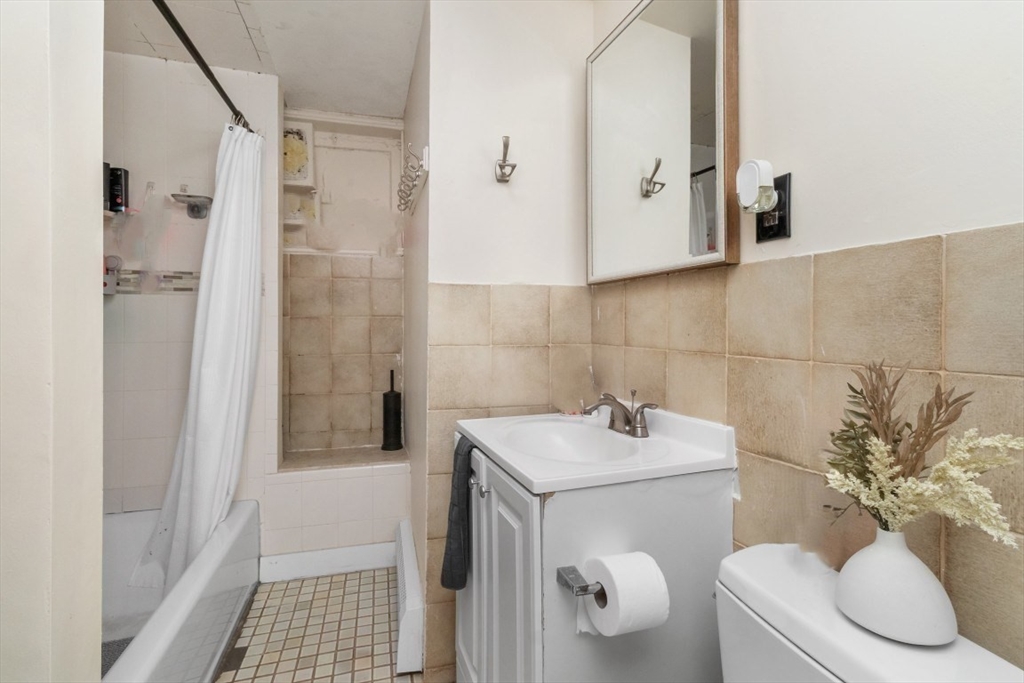 8 Colliston Road Boston, MA 02135 - Photo 29 of 40 a bathroom with a sink toilet and shower