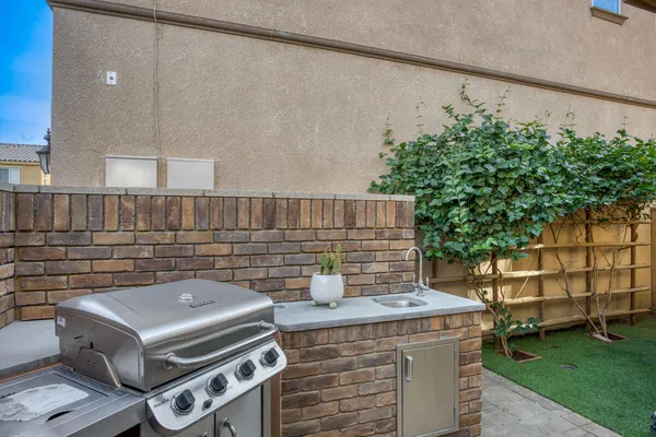 a view of a swimming pool with a patio and wooden fence