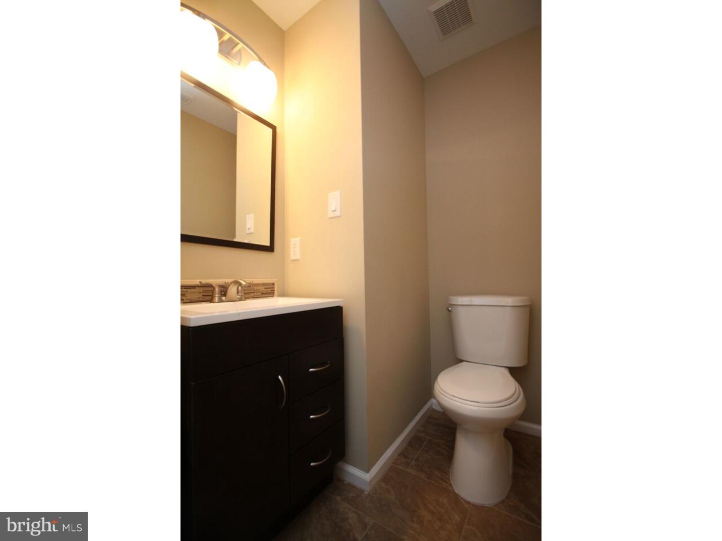 13 Millstream Road Pine Hill, NJ 08021 - Photo 20 of 22 a bathroom with a toilet a sink and mirror