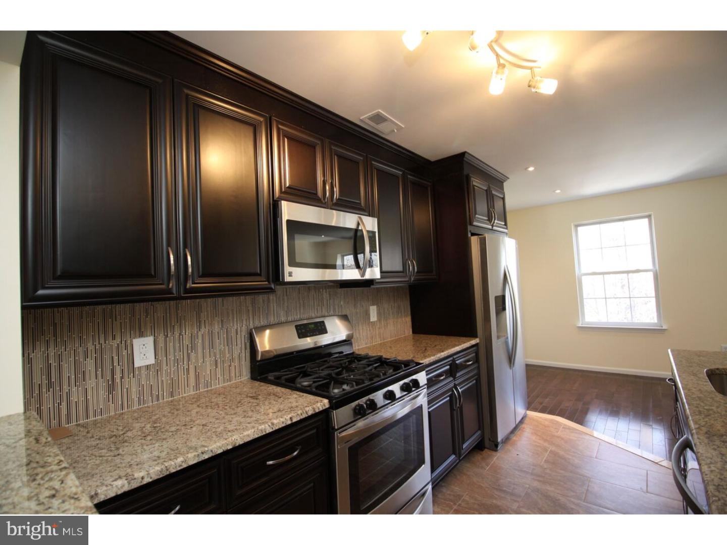 13 Millstream Road Pine Hill, NJ 08021 - Photo 5 of 22 a kitchen with stainless steel appliances granite countertop a stove a sink and a microwave