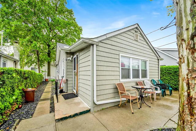 a view of a patio with a table and chairs and potted plants