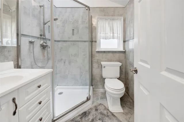 a bathroom with a granite countertop toilet a sink and bathtub