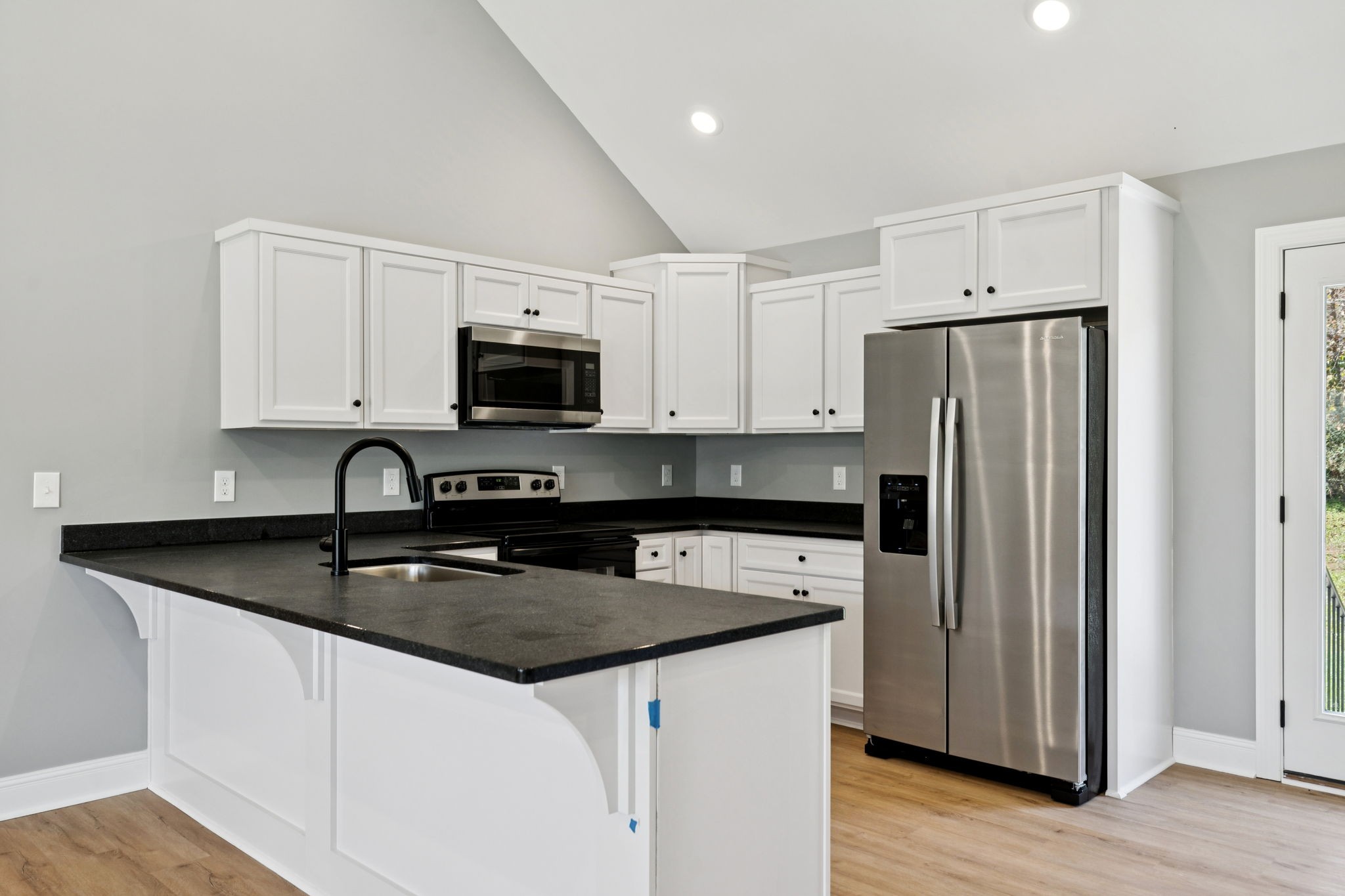 1578 Big Dry Creek Road Pulaski, TN 38478 - Photo 23 of 45 a kitchen with granite countertop white cabinets and stainless steel appliances