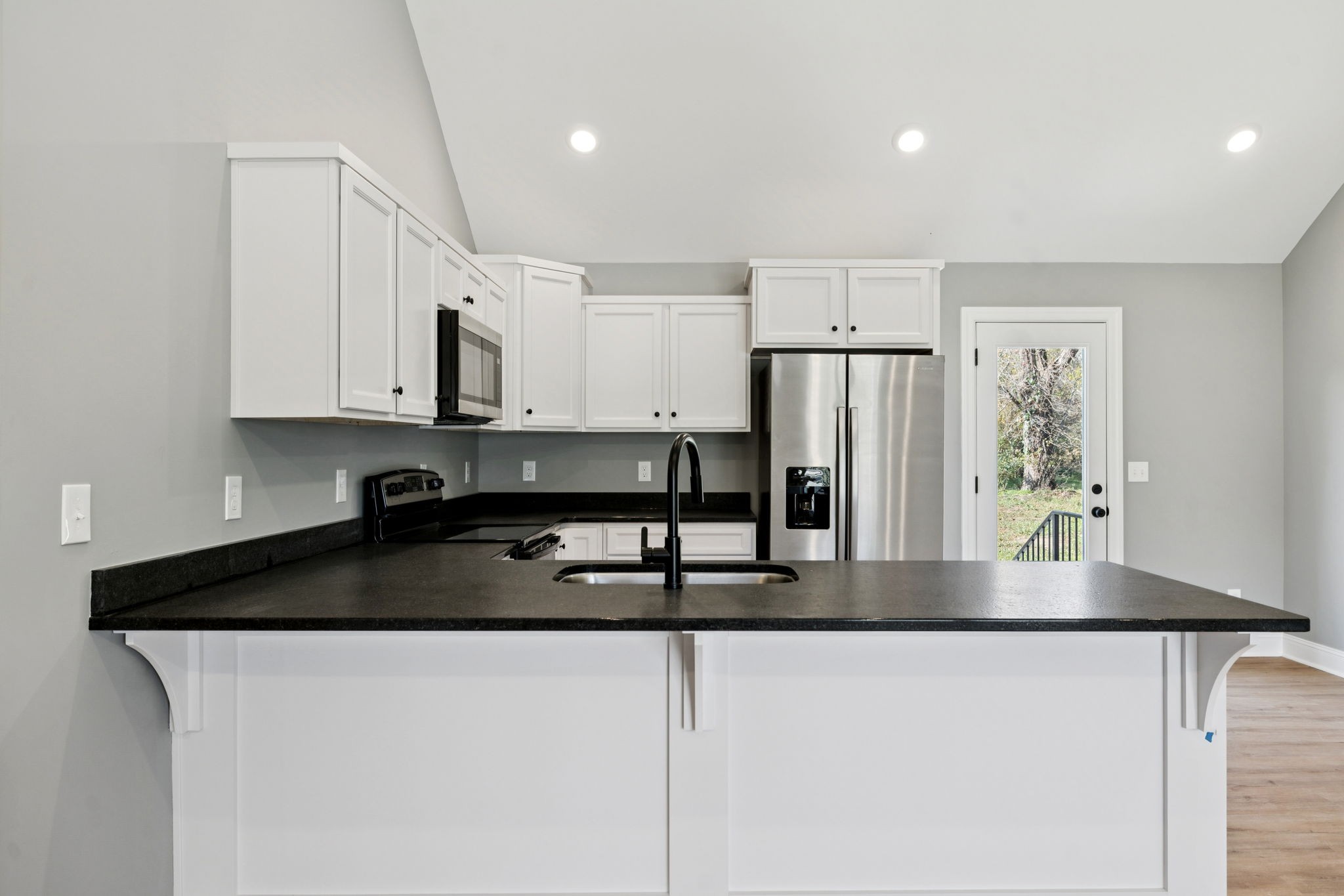 1578 Big Dry Creek Road Pulaski, TN 38478 - Photo 24 of 45 a kitchen with kitchen island a counter space and a refrigerator