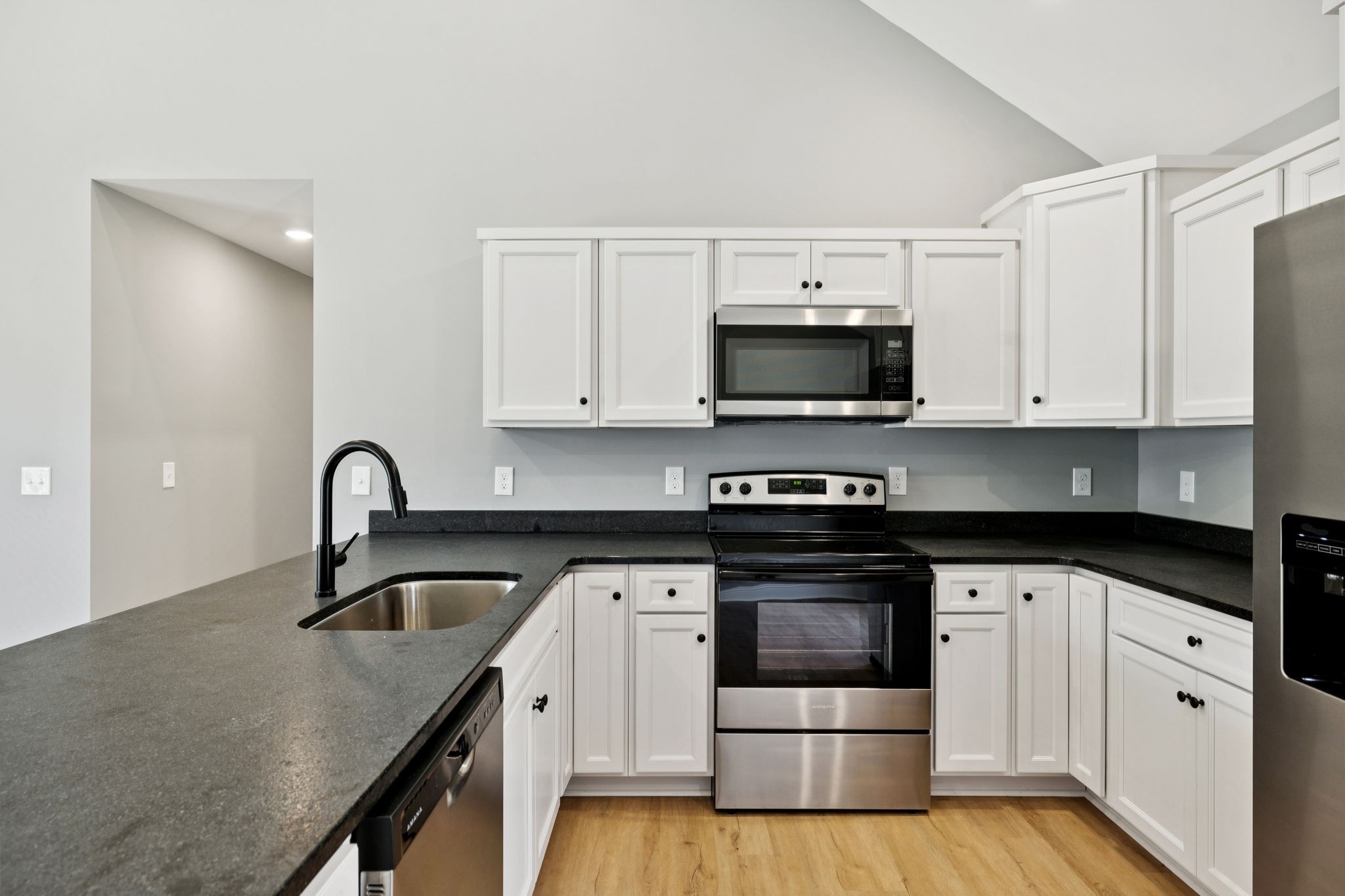 1578 Big Dry Creek Road Pulaski, TN 38478 - Photo 26 of 45 a kitchen with granite countertop white cabinets and stainless steel appliances