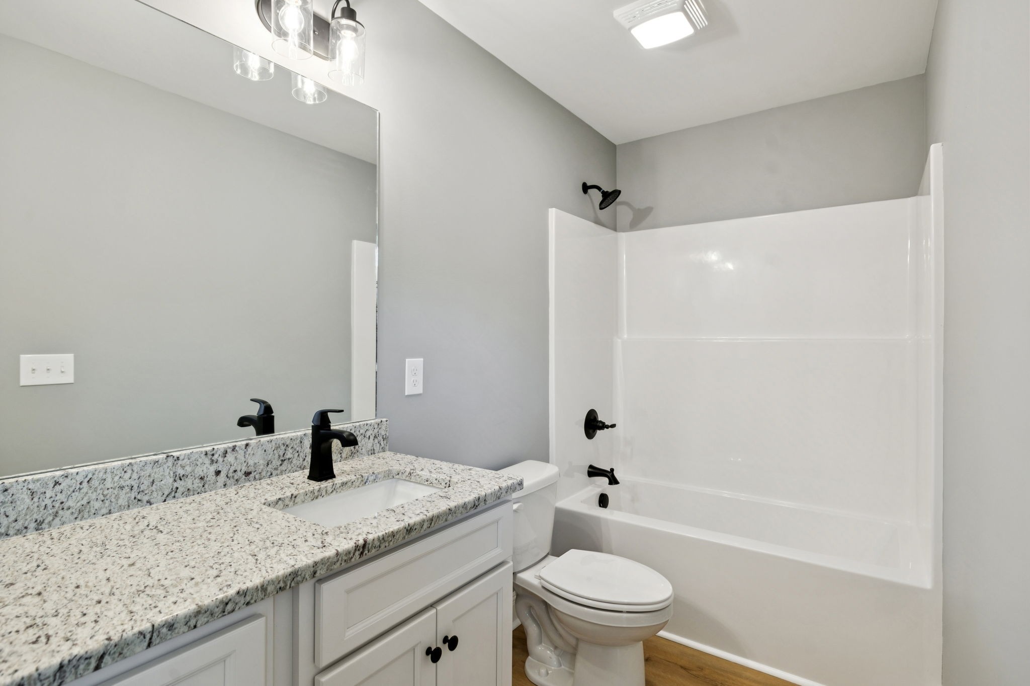 1578 Big Dry Creek Road Pulaski, TN 38478 - Photo 32 of 45 a bathroom with a granite countertop sink a toilet and shower