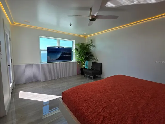 a spacious bedroom with a bed and a couch