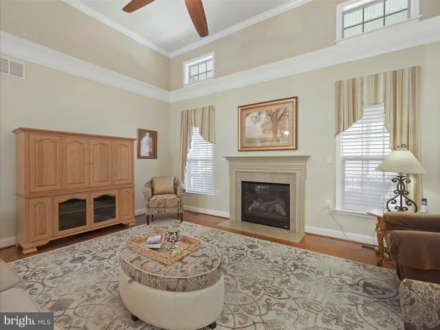 a living room with furniture a fireplace and window