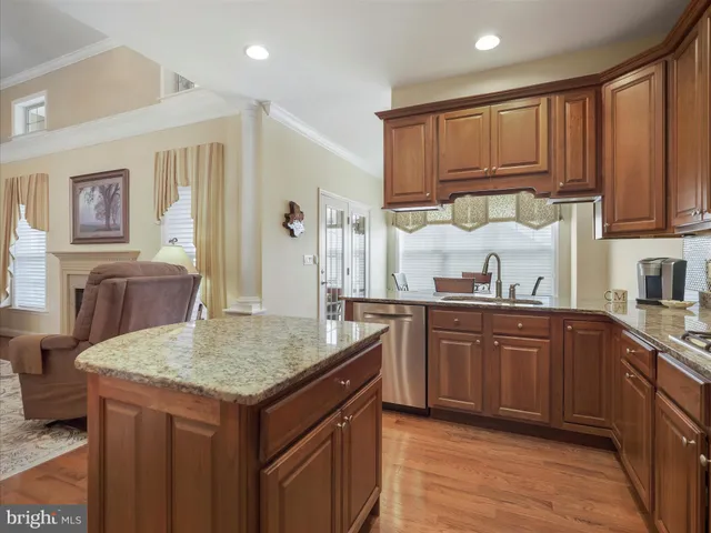 a kitchen with granite countertop a sink and cabinets