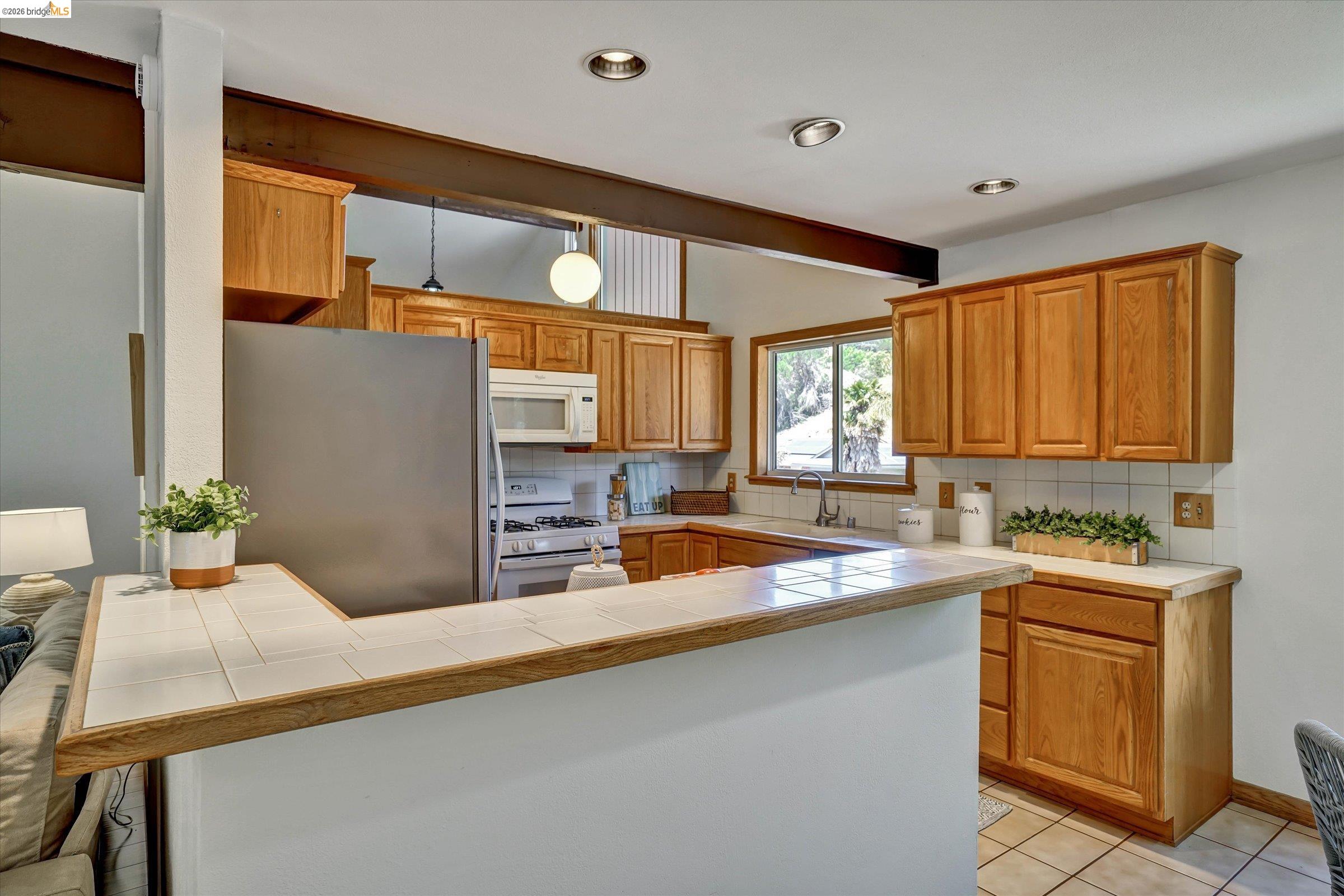 2826 Wright Avenue Pinole, CA 94564 - Photo 17 of 70 Kitchen featuring natural wood cabinetry, stainless steel refrigerator, and built-in microwave