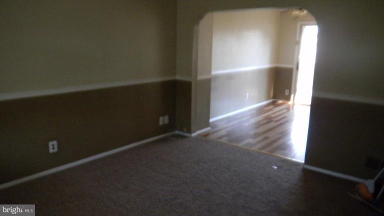 419 Oakwood Road Baltimore, MD 21222 - Photo 1 of 16 an empty room with wooden floor and windows