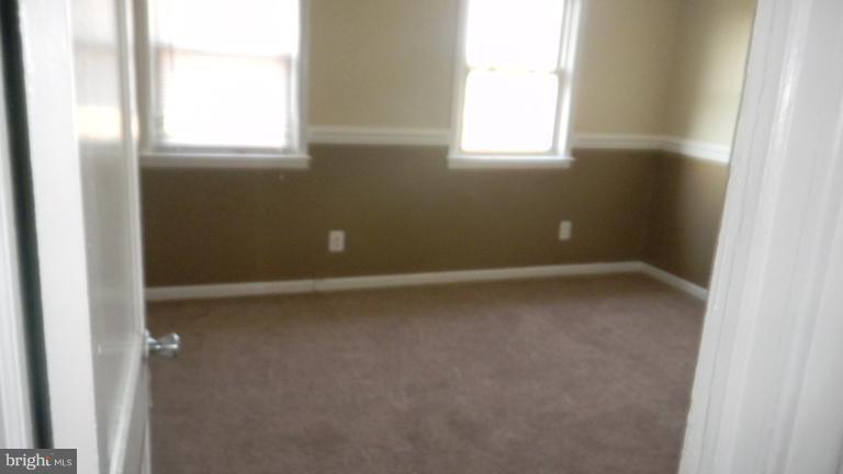 419 Oakwood Road Baltimore, MD 21222 - Photo 3 of 16 a view of an empty room with a window