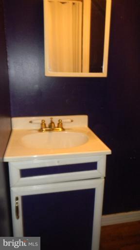 419 Oakwood Road Baltimore, MD 21222 - Photo 9 of 16 a bathroom with a sink and a mirror