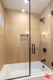 a bathroom with a bathtub and shower