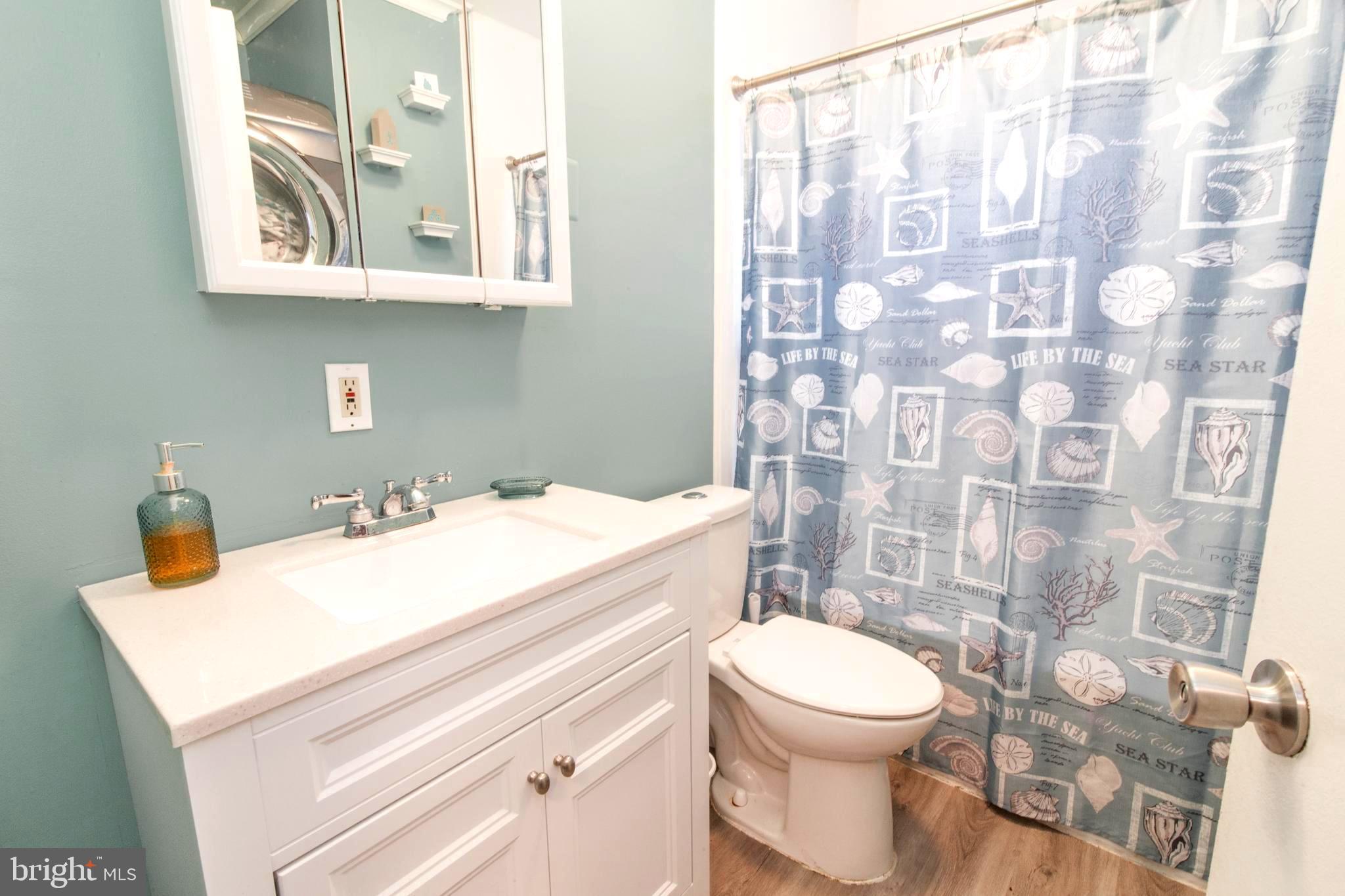 806 Chatfield Road Joppa, MD 21085 - Photo 18 of 28 Main level bath, new cabinet and flooring w/ W/D
