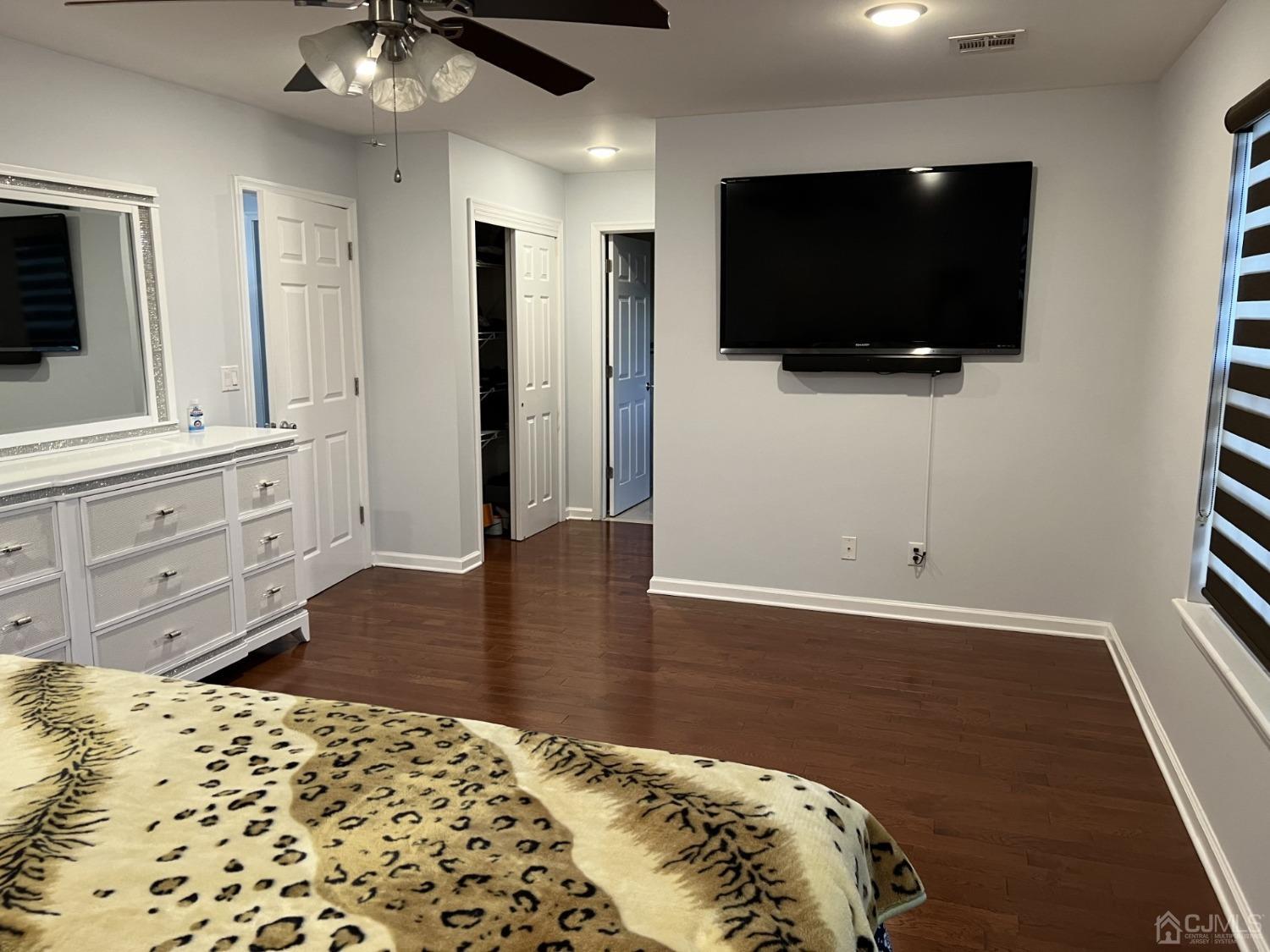 116 B Street Port Reading, NJ 07064 - Photo 12 of 30 a bedroom with a bed and a flat screen tv
