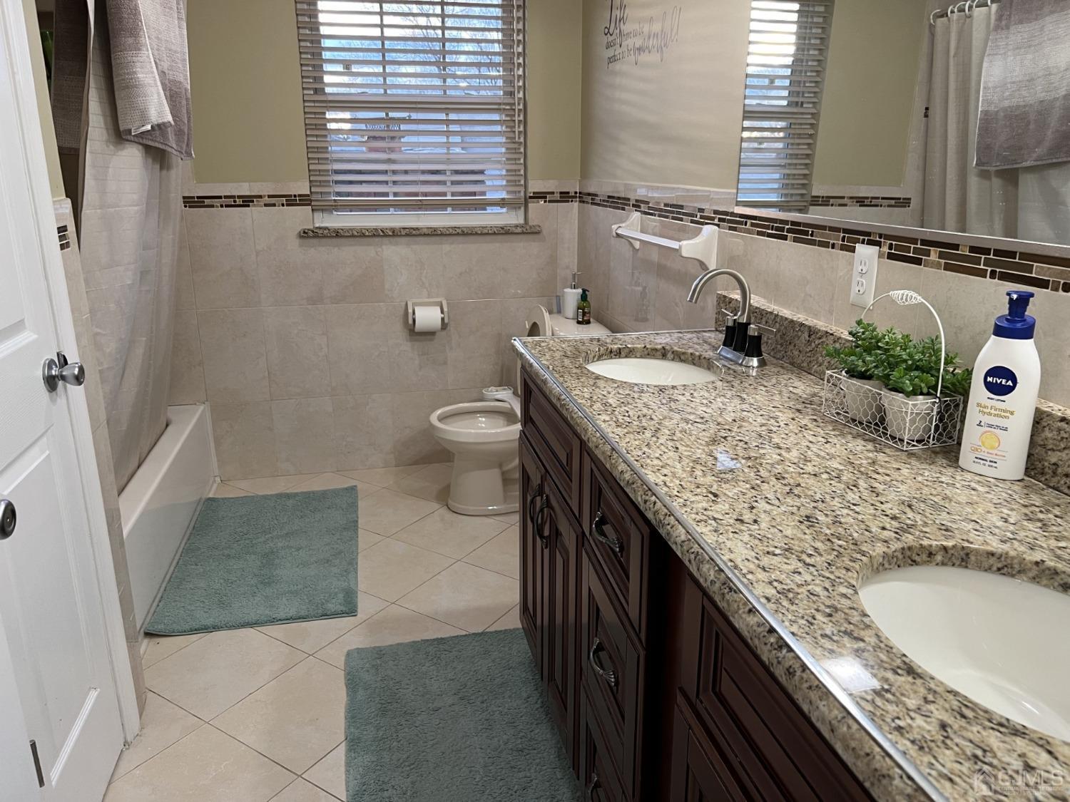 116 B Street Port Reading, NJ 07064 - Photo 14 of 30 a bathroom with a granite countertop sink and a mirror