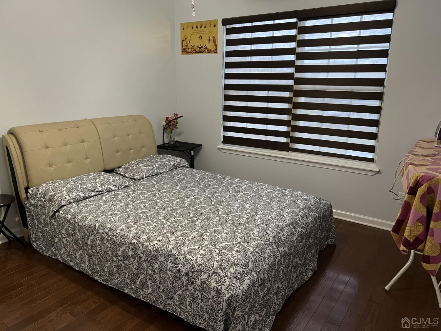 116 B Street Port Reading, NJ 07064 - Photo 15 of 30 a bed sitting in a bedroom next to a window