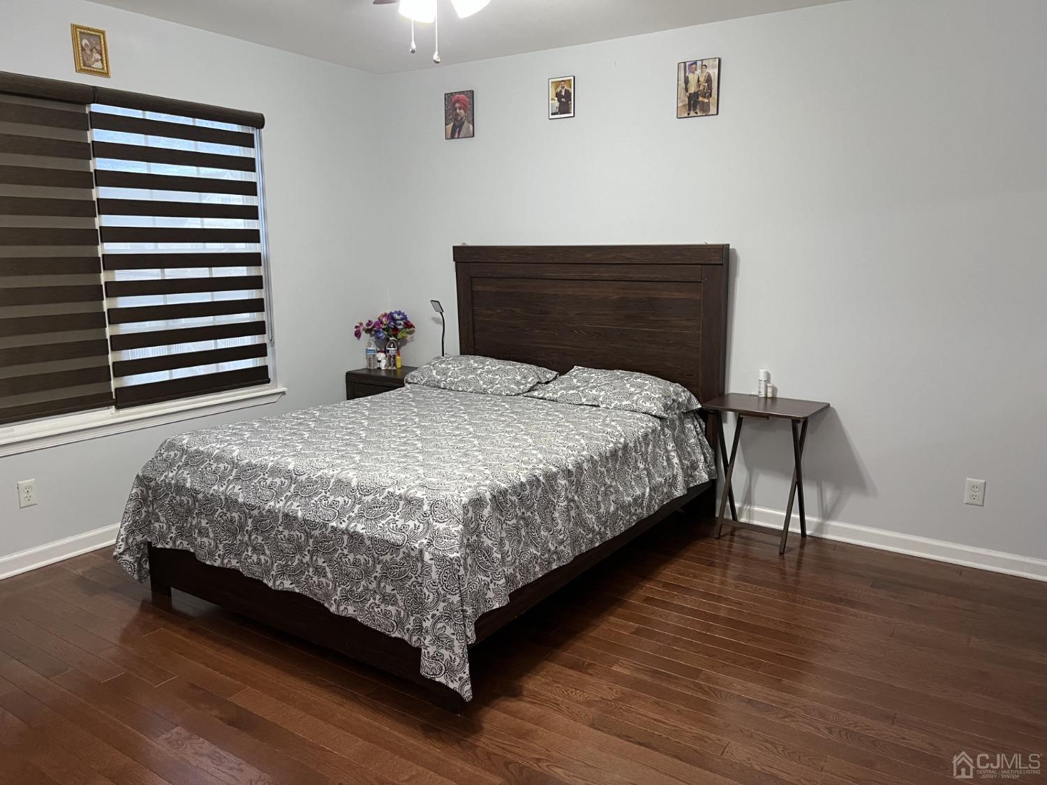 116 B Street Port Reading, NJ 07064 - Photo 16 of 30 a bedroom with a bed lamp and wooden floor